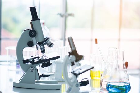 science background microscope on white table 