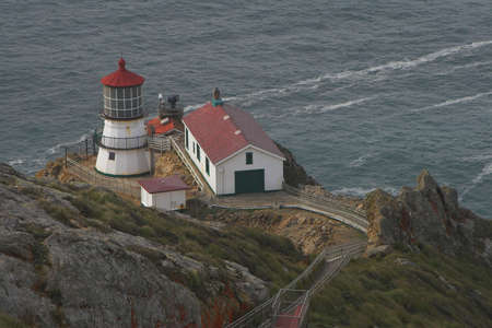 Old lighthouse at Point Reyes with pacific ocean in background, Californiaの写真素材