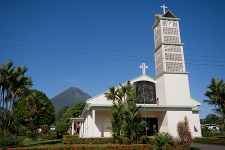 Church on main square of La Fortuna village, Costa Rica, with Arenal Volcano in backgroundの写真素材