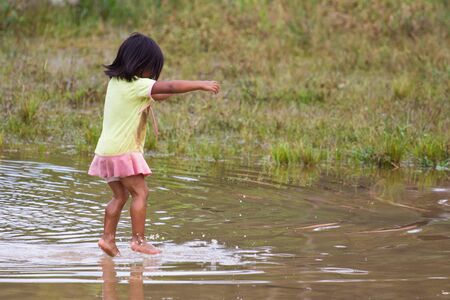 Puyopungo, Ecuador - January 7, 2012 - An indigenous Quichua girl jumps playfully in water  The Quichua are the largest of the South American Indian indigenous groups のeditorial素材