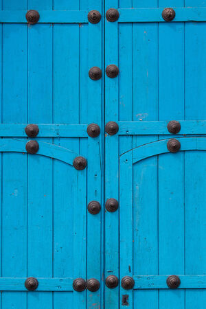 Closed woodem blue gate to a building in Peru, Sacred Valleyの写真素材
