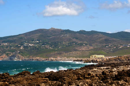 Portugal beach mountain cliff drops splashing waterの写真素材