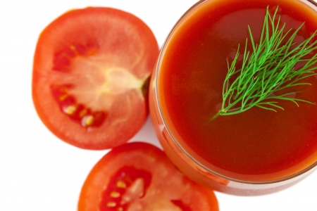 a top view of glass of tomato juice with dill and split tomatoes isolated over whiteの写真素材