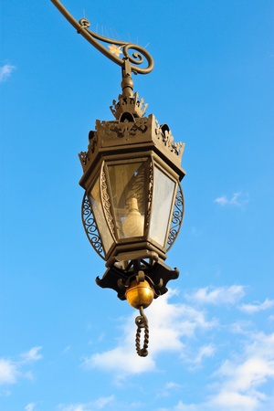 wrought-iron lantern  hanging with sky on the backgroundの写真素材