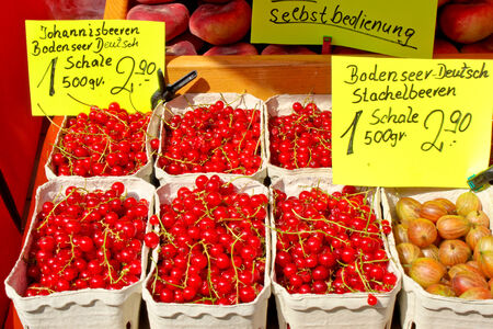 red currants and gooseberries for sale on the marketの写真素材