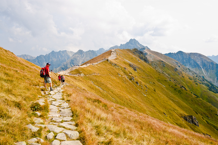 KASPROWY WIERCH, POLAND - SEPTEMBER 3: A man equipped for hiking standing on the walking path in Tatra mountains on September 3, 2012 on Kasprowy Wierch, Poland.のeditorial素材