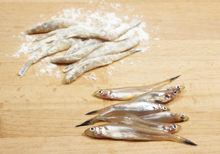 FRESH SMELTS osmerus eperlanus WITH OTHERS WITH FLOUR BEFORE FRYINGの写真素材
