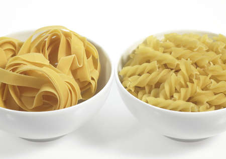 Tagliatelle and Twisted Pasta Against White Backgroundの写真素材