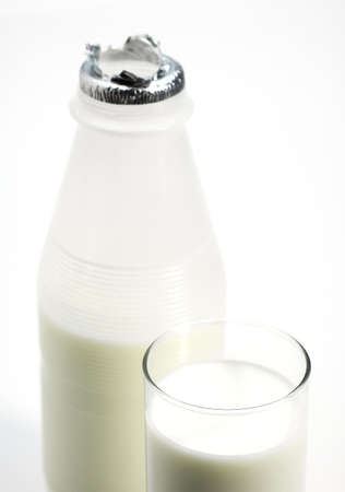 Glass and Bottle of Milk against White Backgroundの写真素材
