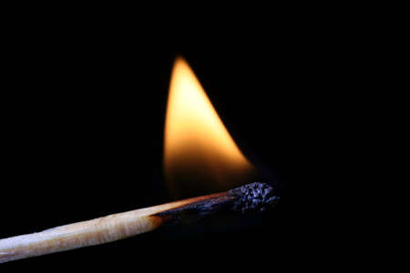 Burning Match Stick isolated on black backgroundの写真素材