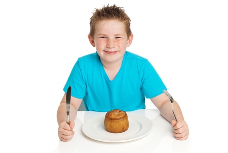 Boy eating pork pie  Studio white background の写真素材