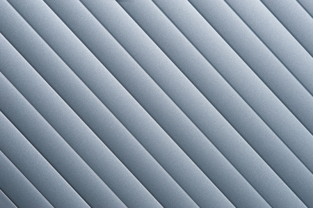 Detail of silver grey roller door blind with parallel striped lines の写真素材