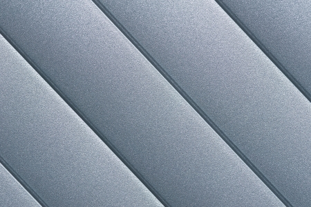 Close up detail of silver grey roller door blind with parallel striped lines の写真素材