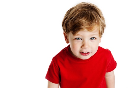 Cute boy looking up, wearing a red T-Shirt in a studio on a white background.の写真素材