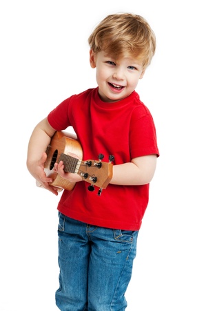 Boy singing and playing guitar shot in the studio on a white background.の写真素材