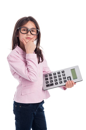 Clever girl with glasses and a calculator doing a calculation. Isolated on a studio white background.の写真素材
