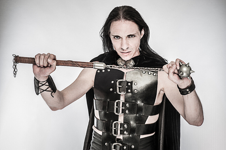Costume character studio shot of fantasy warrior with spiked club.の写真素材