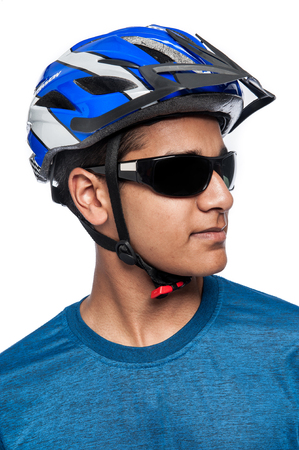 Young man glacing to the side in bycycle helmet. Studio on white background.の写真素材