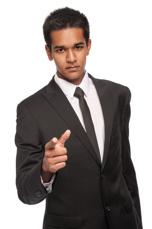 Young man in suit and looking angry and accusing. Studio white background.の写真素材