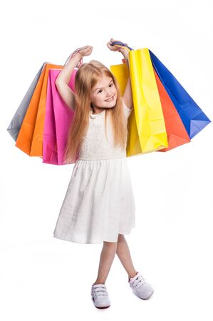 Young child excited with shopping bags.の写真素材