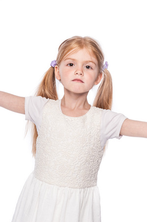 Striking pose young girl looking straight at camera in studio on white background.の写真素材
