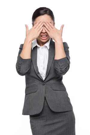 Woman feeling shock horror disgust covering face with hands. Studio shot on white background.の写真素材