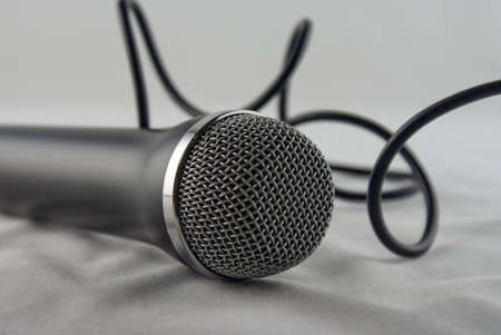 A microphone and cord on a white backgroundの写真素材