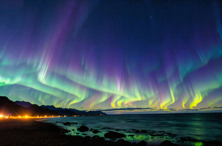 Aurora borealis in the night sky over the sea.の素材