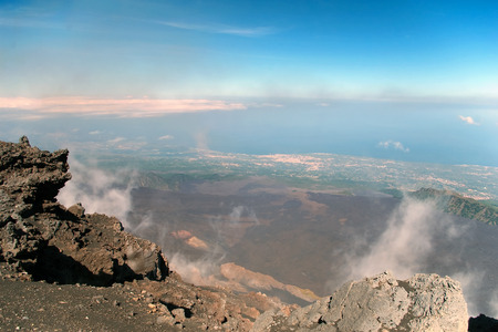 View from mount Etna with sea and towns beneath, Sicily, Italyの写真素材
