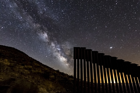 The Milky Way appears through a gap in the international border wall in San Diego County.のeditorial素材