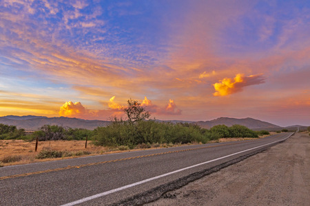 Colorful sunset over a desert highway in the Anza-Borrego Desertの写真素材