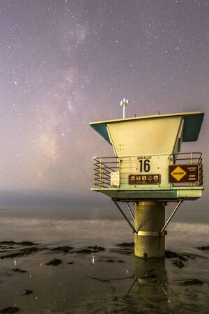 Milky Way galaxy and a lifeguard tower on the beach in southern Californiaの写真素材