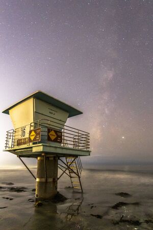 Milky Way galaxy and a lifeguard tower on the beach in southern Californiaの写真素材