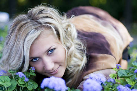 Blond at blue flowers - 1の写真素材
