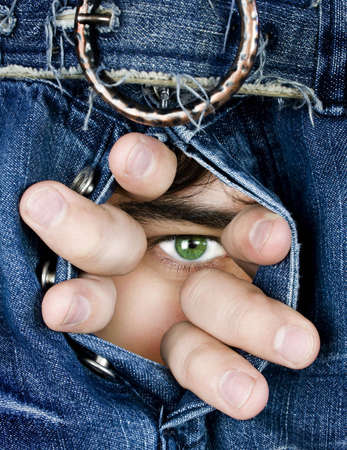 Steadfast sight through dark blue jeansの写真素材