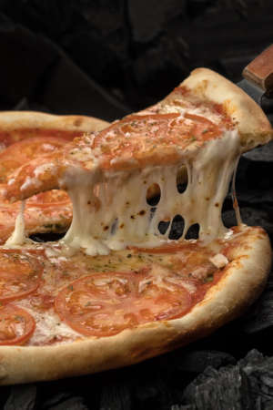Pizza with cheese and tomatoes, food photographyの写真素材