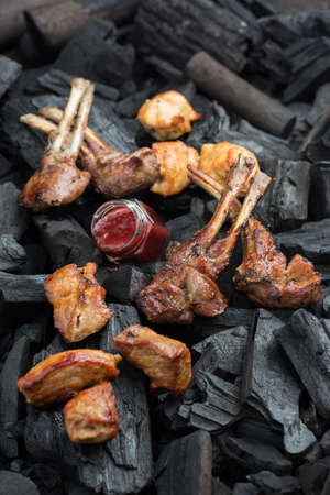 Grilled ribs, charcoal background. Photo of food on a dark backgroundの写真素材