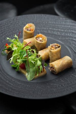 Snack on a black plate. Photo of food on a dark background