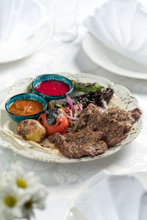 Grilled meat and vegetables, Azerbaijani cuisine. Photography against a white background.