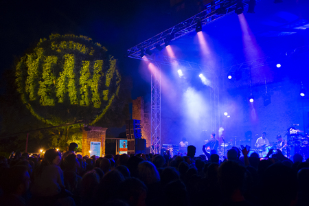 Yeah Music Festival live performance, France with a view across the heads of the audience to the band on the stage under blue lightingのeditorial素材