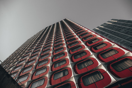 Colorful red modern architecture Beaugrenelle, Paris France looking up the exterior of the building from belowの写真素材