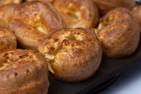 A close up of a Yorkshire pudding that is sitting inside the tray after being baked