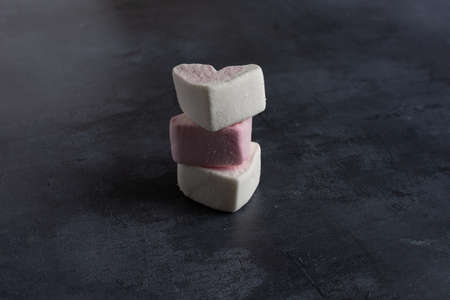 A stack of three love heart marshmallows viewed from the sideの写真素材