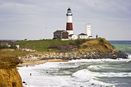  Montauk Point Lighthouse and two fishermen taken from the cliffs of Camp Hero state park  located at  Montauk Point,  Long Island, New York.の写真素材