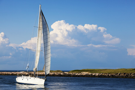 Sailboat coming in the inlet Montauk Point, Long Island , New York の写真素材