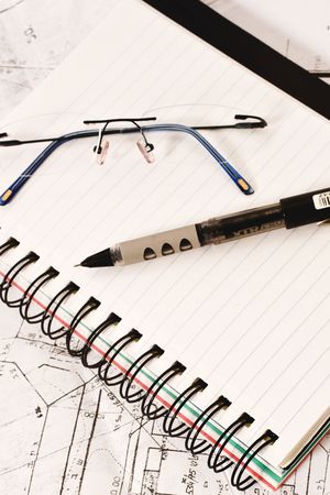 notebook with pen and glasses
