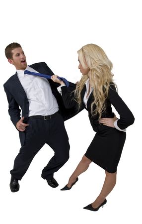 female pulling tie of man on isolated backgroundの写真素材