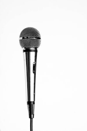 Silver microphone with black wire isolated on whiteの写真素材