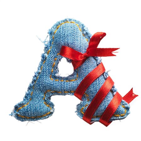 Handmade letter of jeans alphabet with holiday red ribbon isolated on whiteの写真素材
