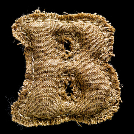 Linen or hemp vintage cloth letter B isolated on black backgroundの写真素材